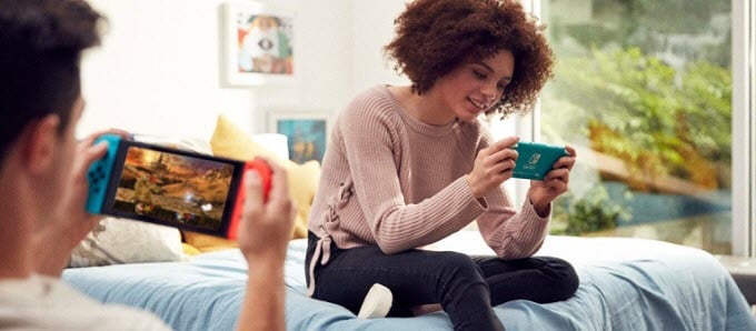Nintendo-Press-Image-Guy-and-Girl-on-Bed - Online Tech Tips Who Should Buy a Nintendo Switch Lite? image - Nintendo-Press-Image-Guy-and-Girl-on-Bed