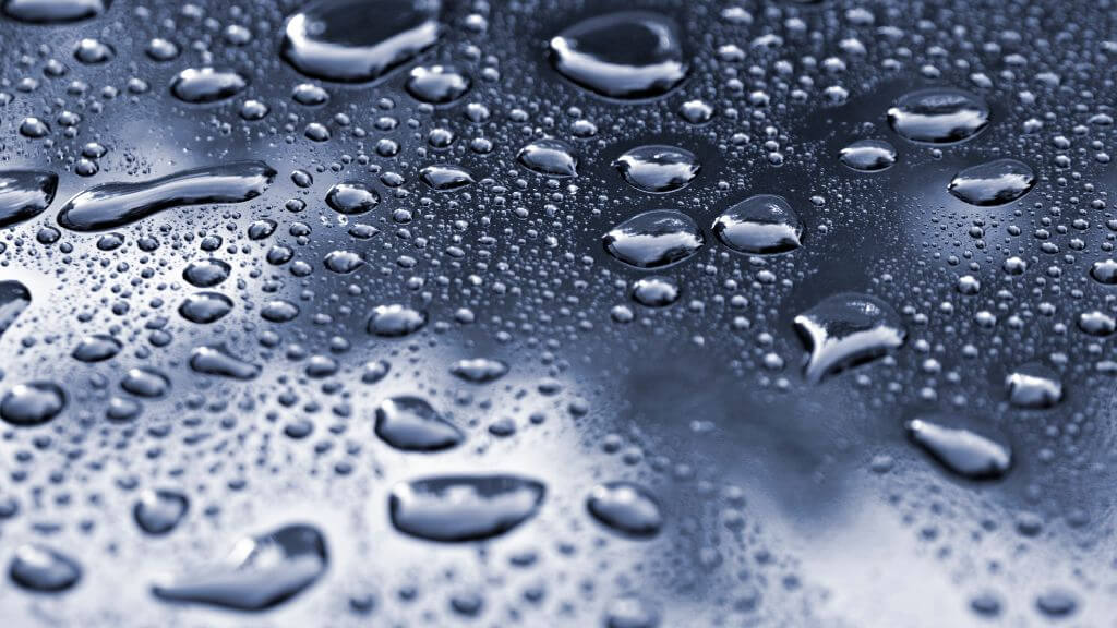 Water droplets of varying sizes on a smooth surface