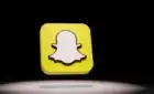 Stylized Snapchat logo floating against black background