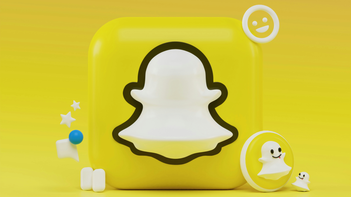 A 3D Snapchat ghost logo sits on a yellow square; it is surrounded by small, yellow, 3D icons - preview-media-1-snapchat-featured