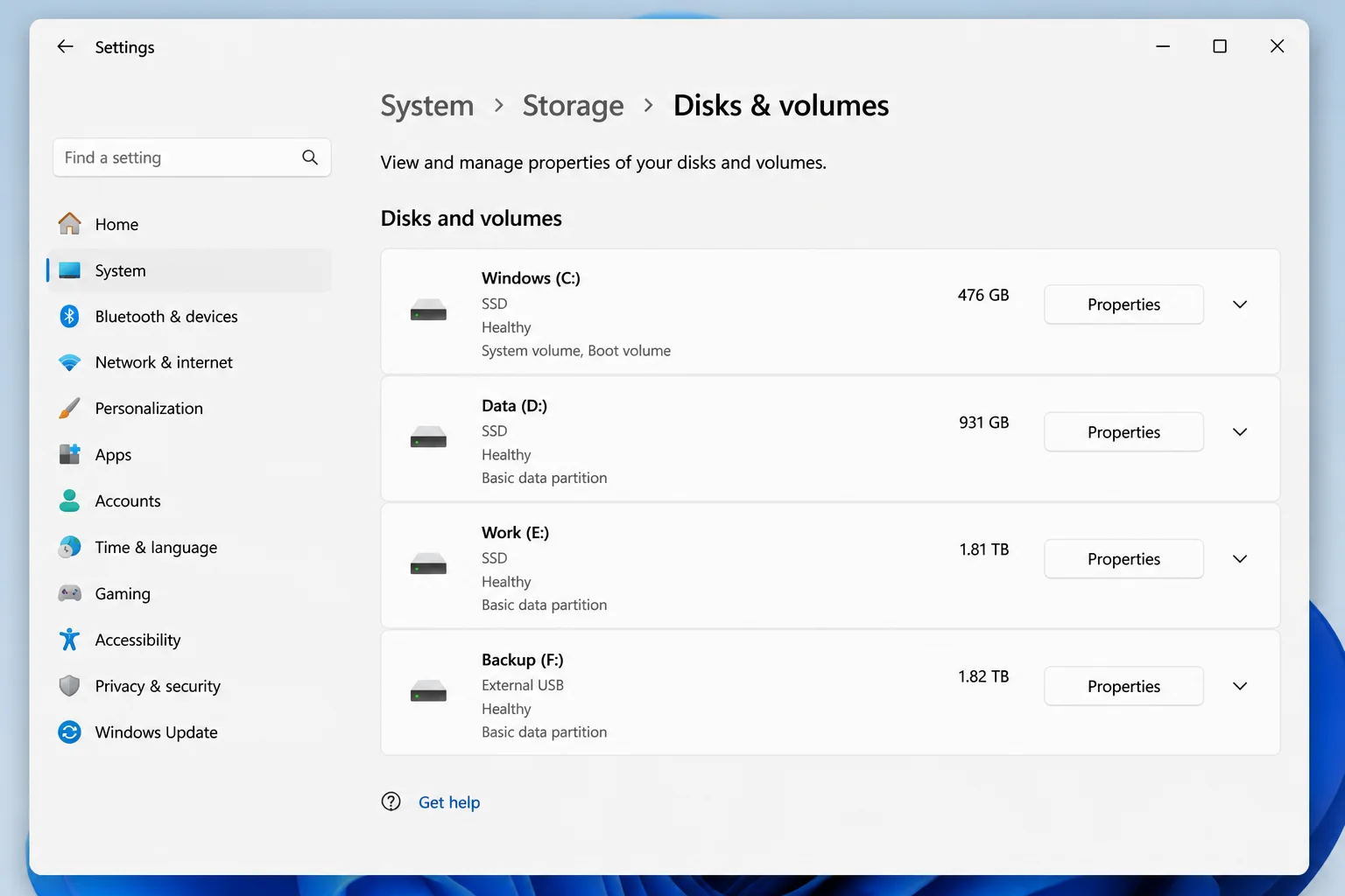 Windows 11 Settings > System > Storage > Advanced storage settings > Disks & volumes page showing connected drives