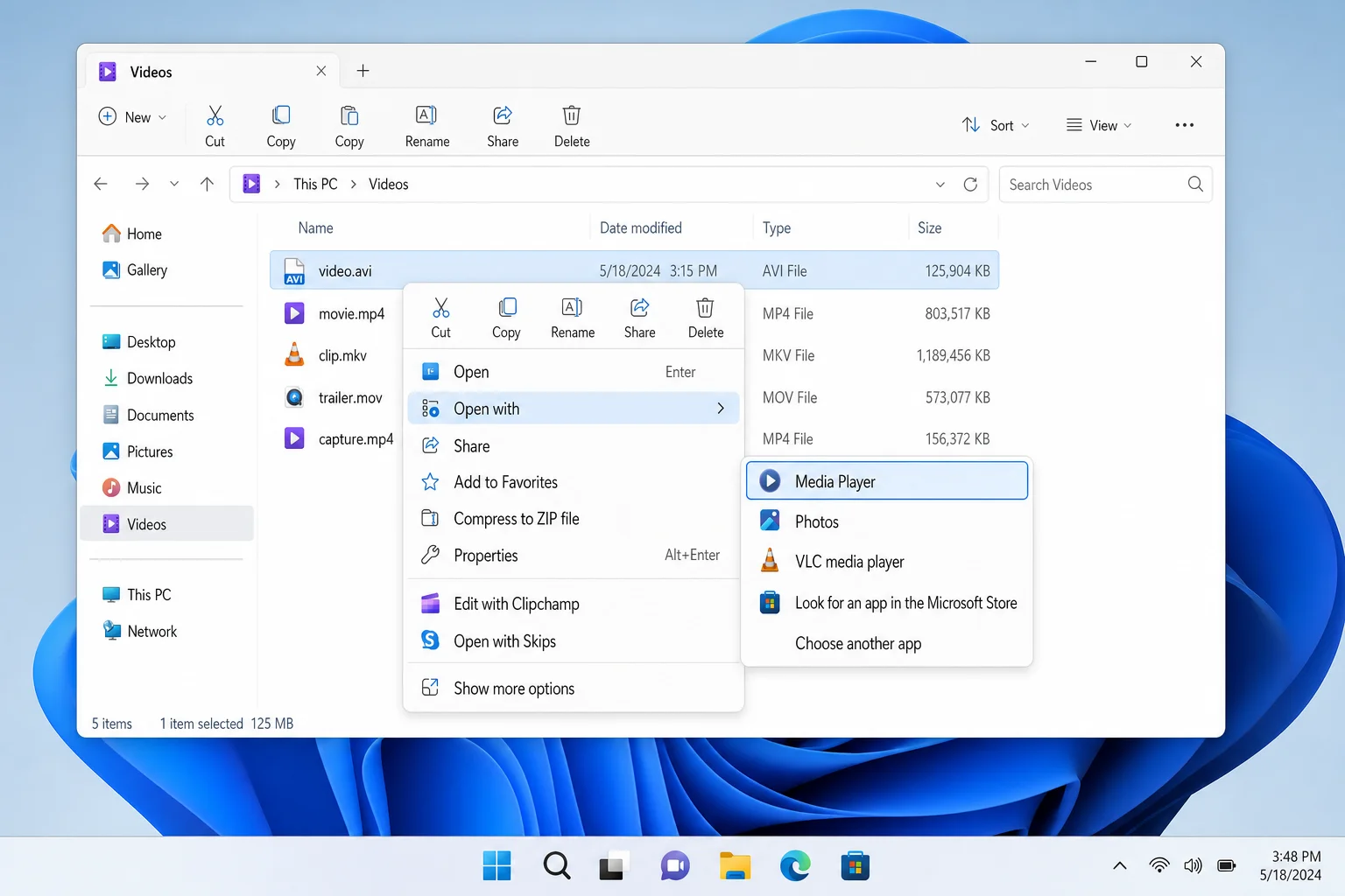 Windows 11 File Explorer showing right-click context menu with "Open with" > "Media Player" option highlighted for an AVI file