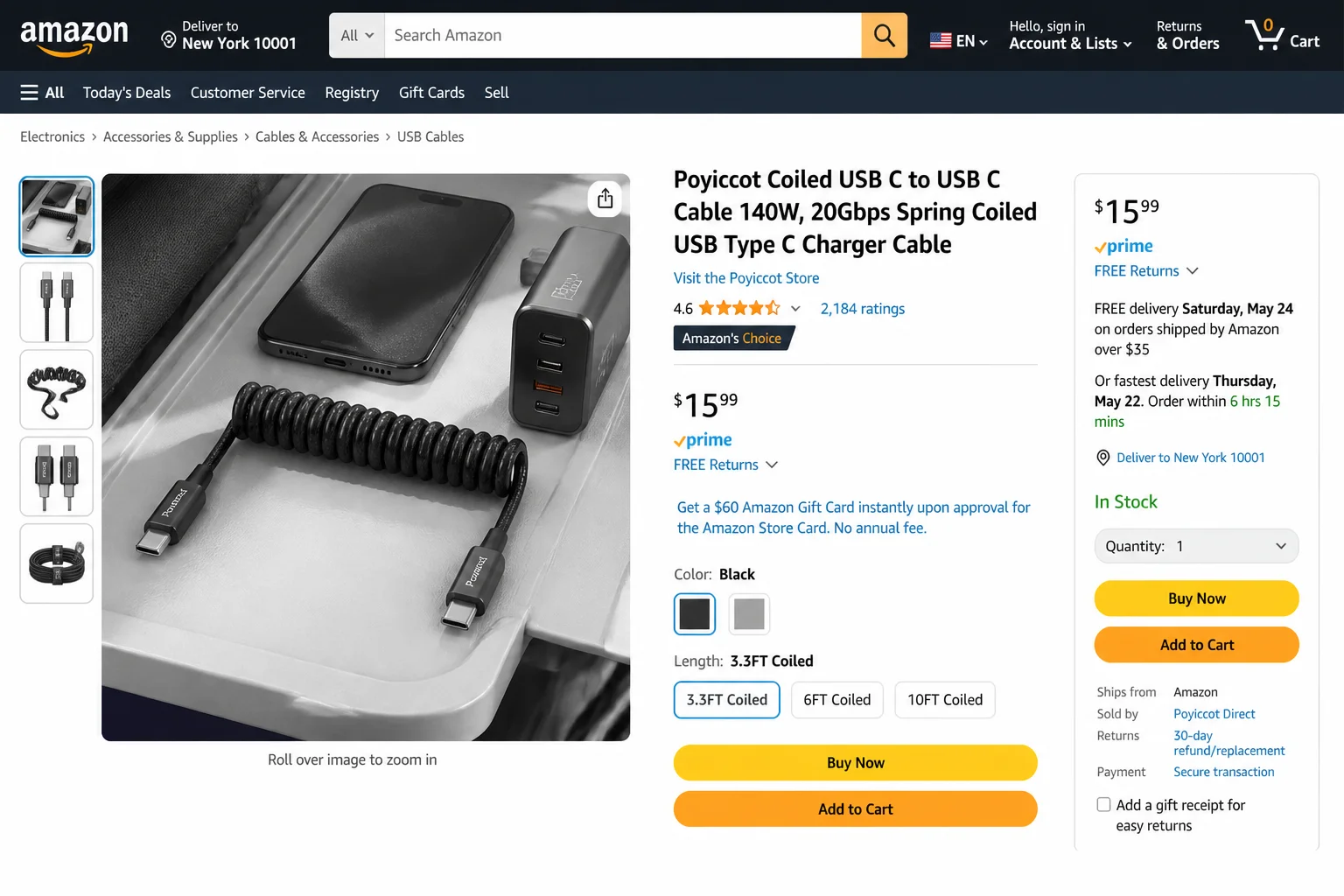 Braided USB-C to USB-C cable coiled neatly next to a smartphone and compact charger on a travel surface