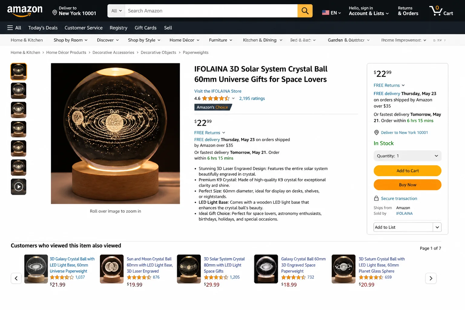 Laser-engraved solar system crystal ball on a wooden display stand, with the planets and orbital paths glowing inside, lit from beneath