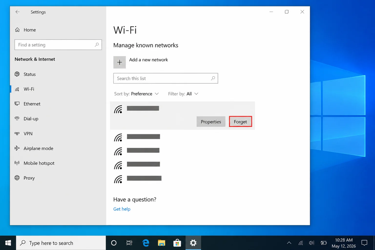 Windows Manage known networks page showing separate main and IoT networks with Forget highlighted, with actual SSIDs redacted